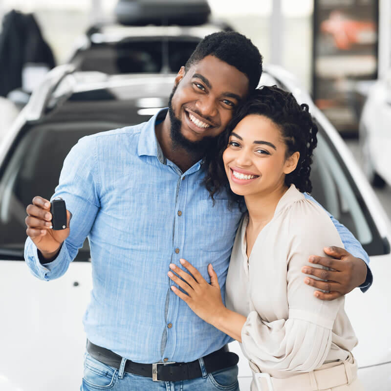 Happy Couple with Keys Buying Used Vehicle